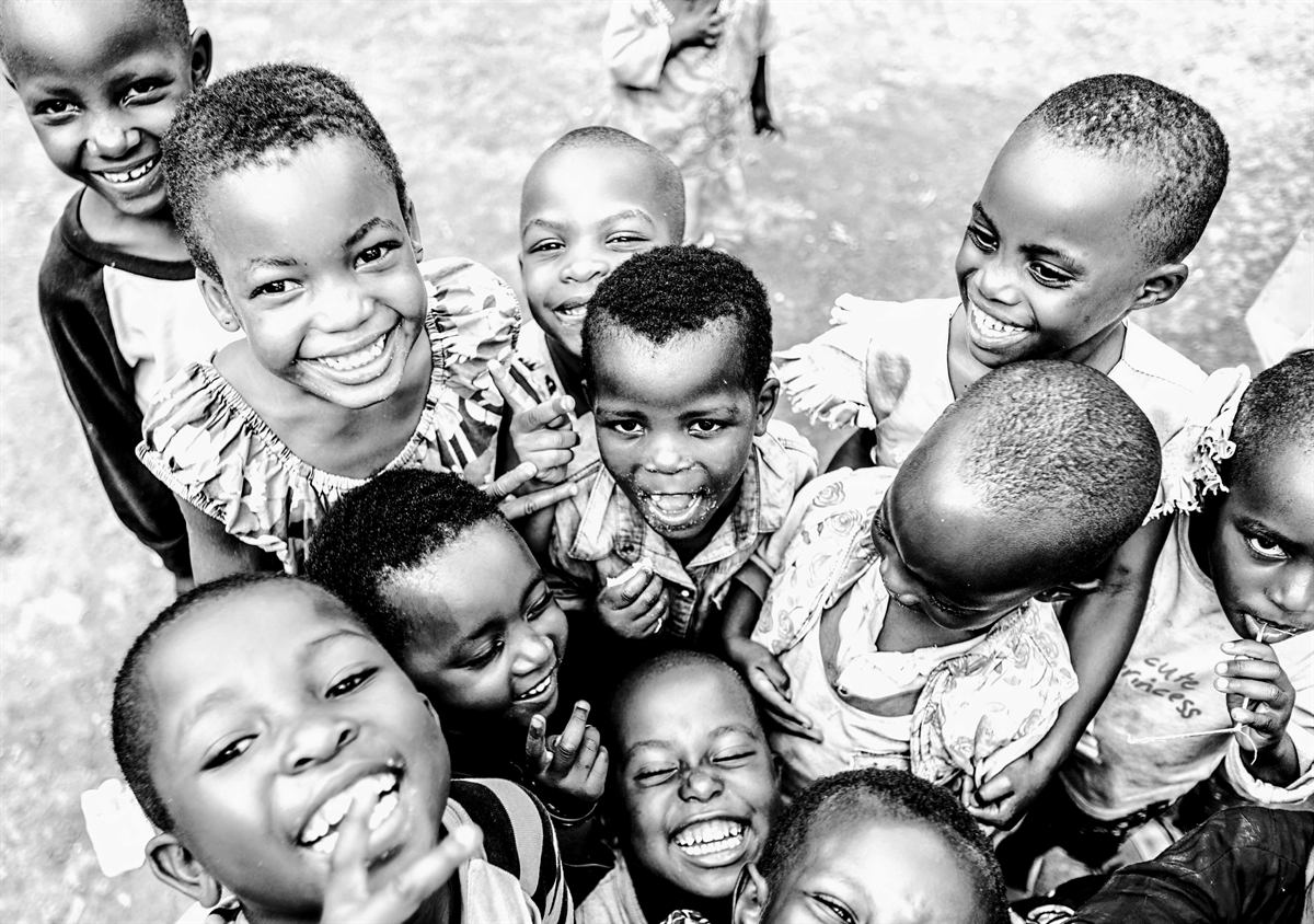 Group of smiling young children looking up at the camera